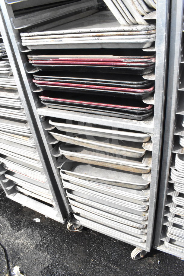 Commercial pan transport rack with 50 baking pans on durable commercial casters. Rack shows signs of use.
