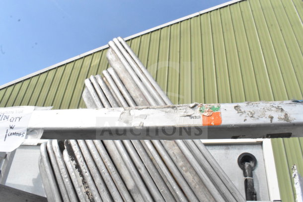 Commercial pan transport rack with 50 baking pans on casters. Visible wear and labels indicate inventory details.