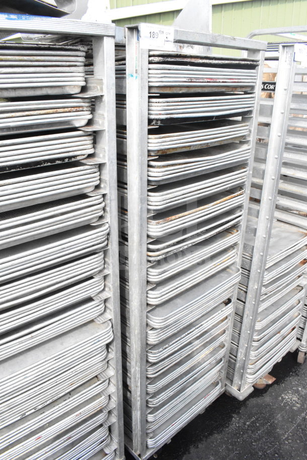 Commercial pan transport rack with 70 baking pans on casters, durable metal, used condition, ideal for baking industry.