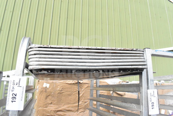 Commercial pan transport rack with 40 baking pans, on heavy-duty casters. Visible auction tags. Used condition.