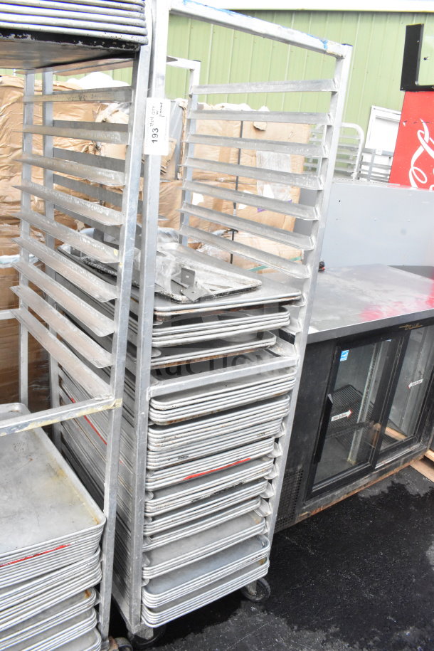 Commercial pan transport rack on wheels with 60 baking pans, showing wear. Tag displays "193."