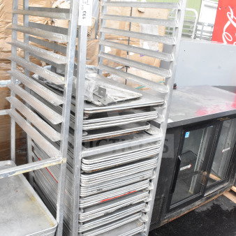 Commercial pan transport rack on wheels with 60 baking pans, showing wear. Tag displays "193."