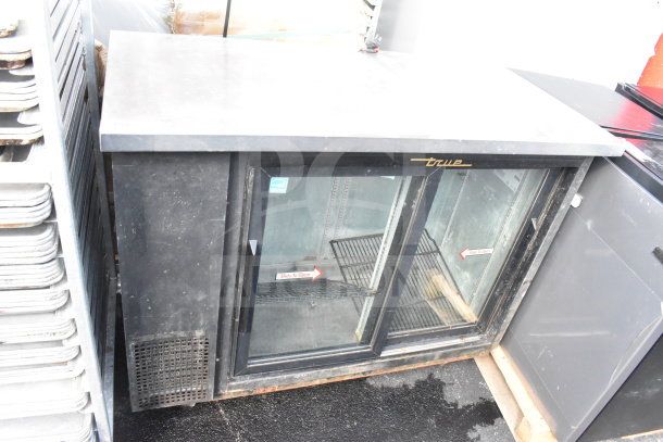 True TBB-24-48G-SD commercial 2-door back bar cooler merchandiser, glass doors, black exterior, 115V, good condition.