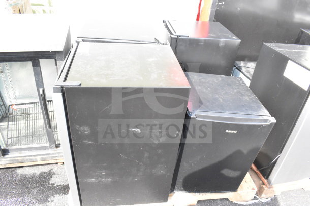 Four mini coolers including Hisense and Galanz models, black finish, used condition, 115 volts, 1 phase, onto pallets.