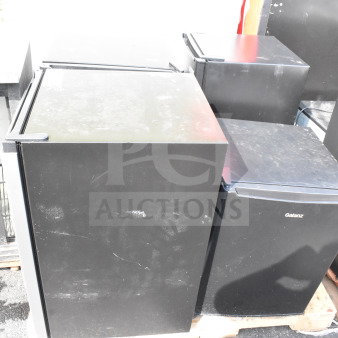 Four mini coolers including Hisense and Galanz models, black finish, used condition, 115 volts, 1 phase, onto pallets.