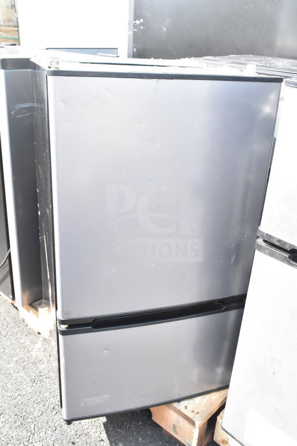 Four mini coolers, including Hisense and Arctic King, 115 volts, 1 phase, displayed on pallet. Slight wear visible.