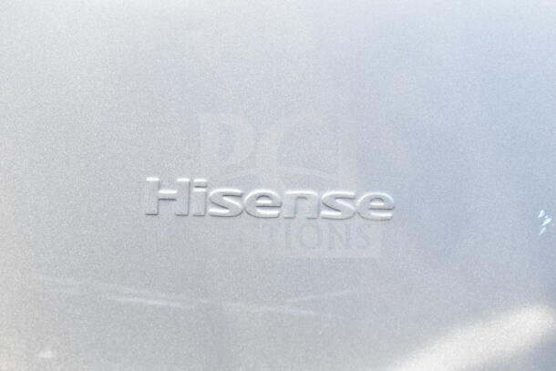 Hisense mini cooler logo on a silver surface, indicating one of four various mini coolers for auction, 115 volts, 1 phase.