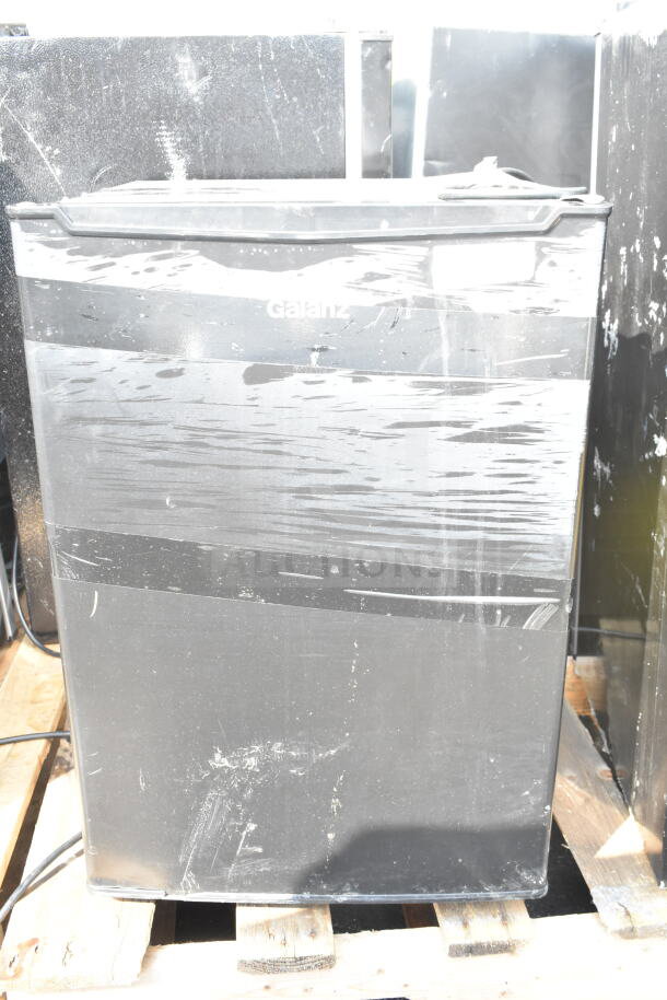 Four mini coolers, including Galanz model, visible scratches, black finish, 115 volts, 1 phase, pallet display.