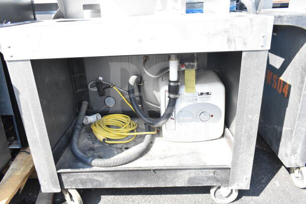 Commercial portable sink on casters with Bosch water heater, visible hoses, and power cords. Signs of wear present.