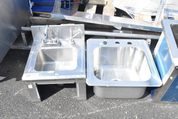 Two stainless steel single bay sinks, including one drop-in model. Features mixer tap, minor wear visible.