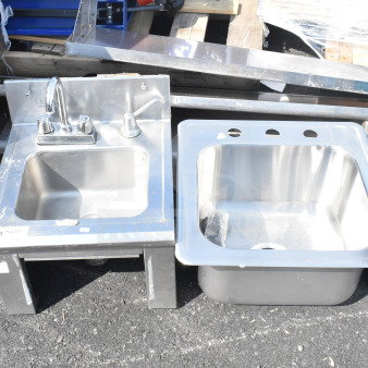 Two stainless steel single bay sinks, including one drop-in model. Features mixer tap, minor wear visible.
