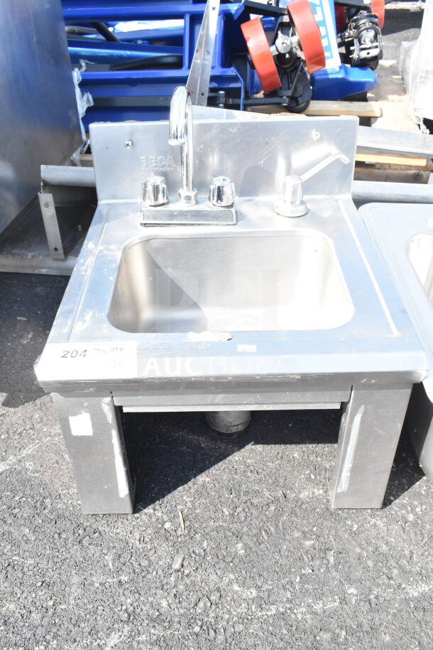 Stainless steel single bay sink with drop-in feature, featuring a faucet and two knobs, with minor surface wear.