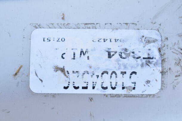 Alt text: Close-up of a label on a single bay sink, showing dirt and wear.