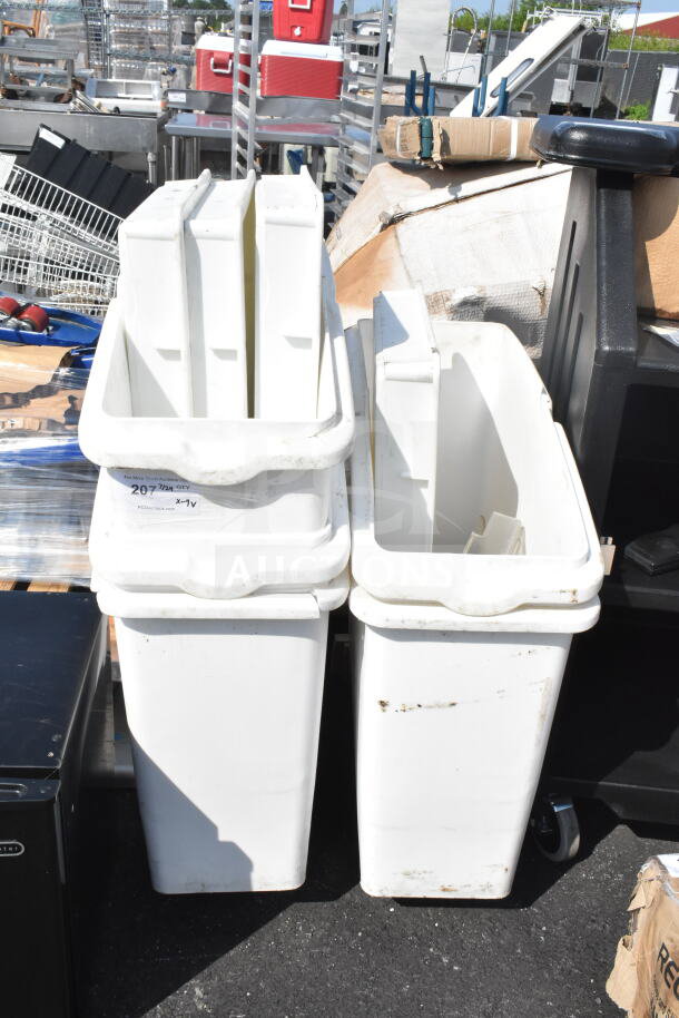 Nine assorted kitchen bins, including ingredient and dough bins. White, used condition. Visible auction label with lot details.