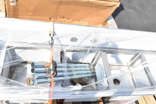Brand new Regency 600S31717218 commercial 3 bay sink with dual drain boards, scratch and dent condition, shown packaged.