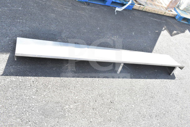 Steel shelf, rectangular, outdoor setting, good condition, elongated shape, suitable for storage or display.