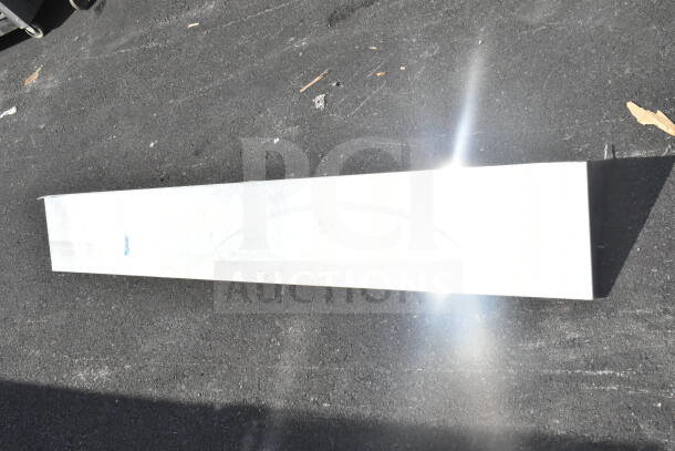 Metal shelf on asphalt, good condition, eligible for bidding. Contains markings indicating weight capacity.