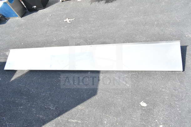 Metal shelf on asphalt, excellent condition, long rectangular shape; part of "3 Various Shelf" auction bundle.