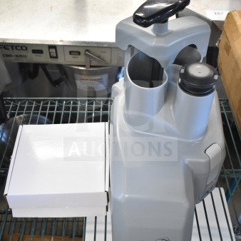 Brand new AvaMix Revolution 928CFEED continuous feed attachment, minor scratches, shown with original box, model markings visible.