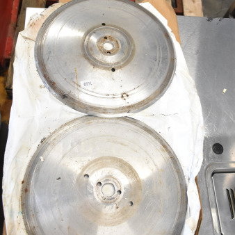 Two metal meat slicer blades, circular design, moderate wear, shown on packaging paper, marked with number 1480.