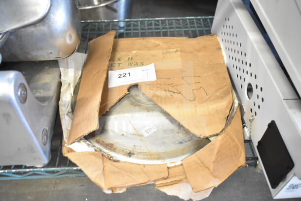 Two meat slicer blades in used condition, partially visible in worn cardboard packaging with auction tag 221.