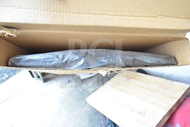 Brand new scratch and dent menu board in cardboard box, partially visible, wrapped in protective plastic.