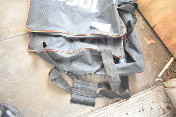 Loco Cookers bag, black with orange piping, visible wear, sturdy handles, ideal for transporting cooking equipment.
