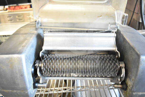 Berkel 705 electric meat tenderizer, commercial countertop model. Visible rollers and cutting blades, good condition. 115V, 1 phase.