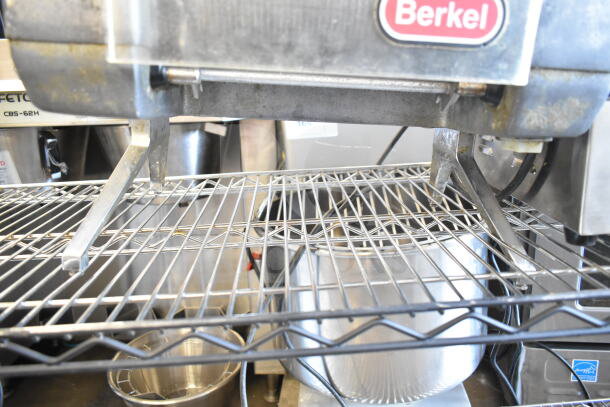 Berkel 705 Commercial Electric Meat Tenderizer on wire rack. Model 705, 115 volts, used condition, visible Berkel logo.