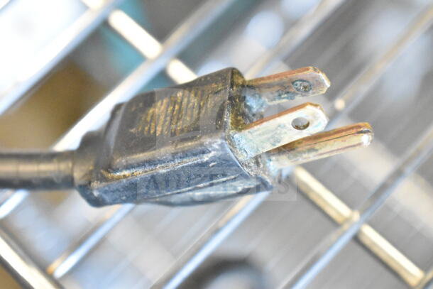 Close-up of the power plug for a Berkel 705 Commercial Meat Tenderizer, 115 volts, showing wear.