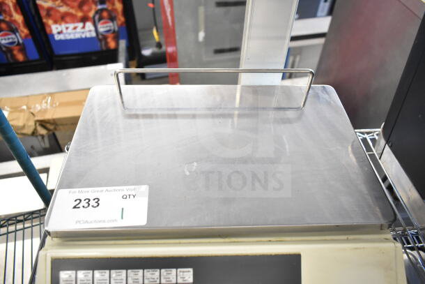 CAS CL5000-R commercial scale, 60 lb capacity, 120 volts, countertop model with keypad, in used condition. Auction label "233".
