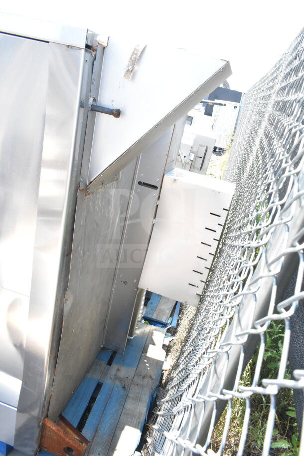 Hobart Commercial Roll In Rack Oven, stainless steel, visible wear on exterior, stored on pallets outdoors.
