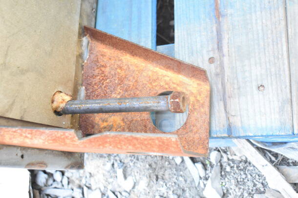 Close-up of a rusty metal component from a Hobart Commercial Roll In Rack Oven, highlighting wear and tear.