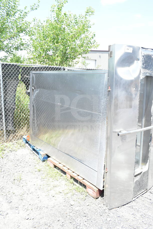Hobart Commercial Roll In Rack Oven, stainless steel, slight dents, located outdoors on pallets, visible door handle.