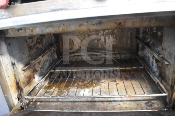 Commercial oven interior with metal rack, showing significant rust and wear. Used condition, suitable for refurbishment.