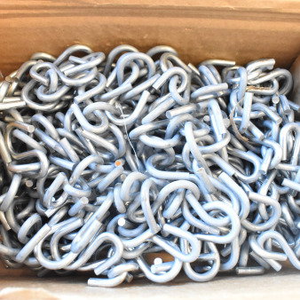 Box of silver metal S hooks, new condition, tightly packed in a cardboard box, ideal for hanging or organizing.