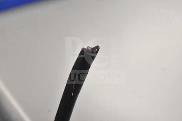 Close-up view of a cut electrical cable, revealing copper wiring inside.