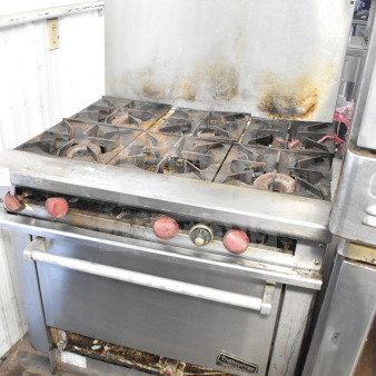 Therma-tek TMDR-6-1N 6-burner gas range with oven and backsplash; visible wear; sturdy commercial-grade unit.