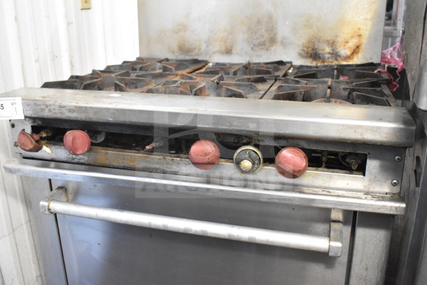 Therma-tek TMDR-6-1N commercial range with 6 burners, oven, backsplash. Visible wear and rust on knobs, stainless steel finish.