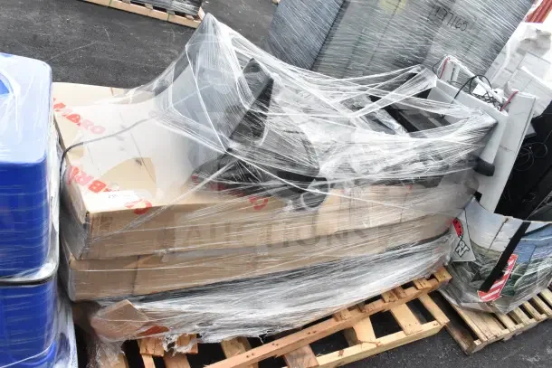 Stacked items on a pallet with protective wrap, including new JUN26-75 grease trap and keg tap kit, showing packaging labels.