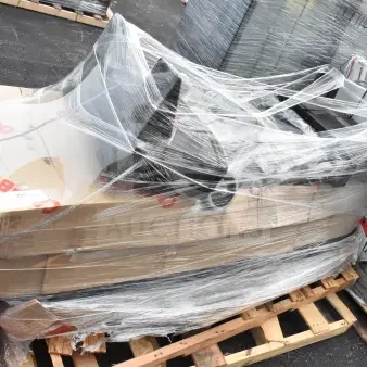 Stacked items on a pallet with protective wrap, including new JUN26-75 grease trap and keg tap kit, showing packaging labels.