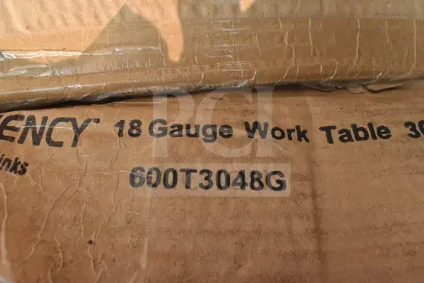 Cardboard packaging labeled "18 Gauge Work Table 30" Model 600T3048G. Contains equipment stand, wire shelves. Brand new, scratch and dent.
