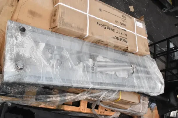 Brand new equipment with scratch and dent, including a Regency 14" x 42" wire shelf. Wrapped and boxed, visible markings.