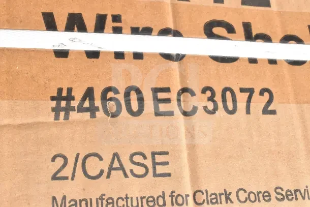 Cardboard box labeled "Wire Shelf #460EC3072, 2/CASE." Box contains scratch and dent items, including drop mat and wire shelf.