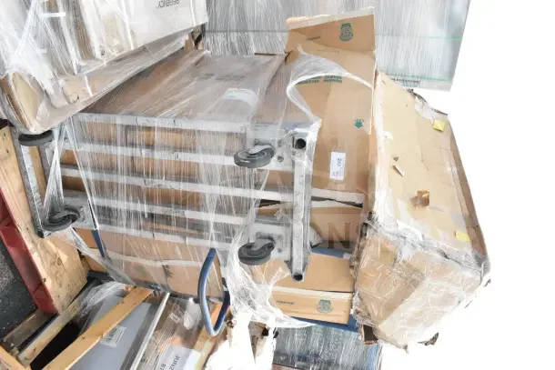Pallet with wrapped boxes marked "243" containing brand new scratch and dent items, including sink bowls and faucets.