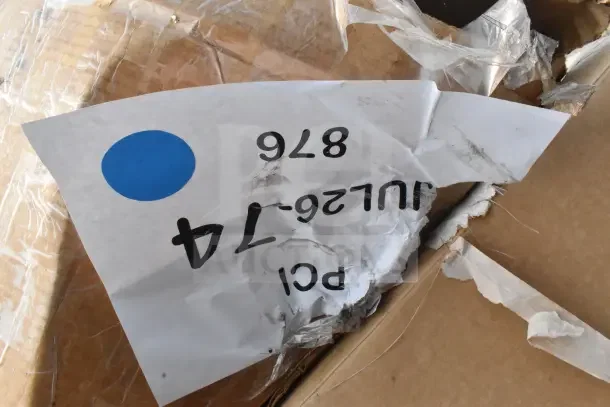 Torn packaging with label "PCI JUL26-74 876" showing a blue dot, indicating part of a scratch and dent auction lot.