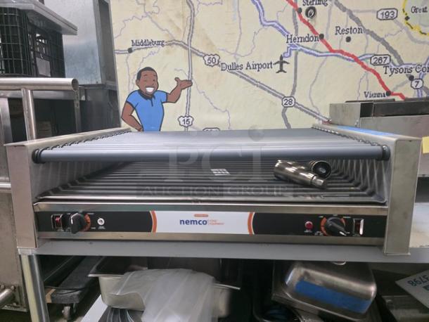 Nemco 8075SX 75 hot dog roller grill, 208V, 60Hz, in good condition, with adjustable temperature controls.