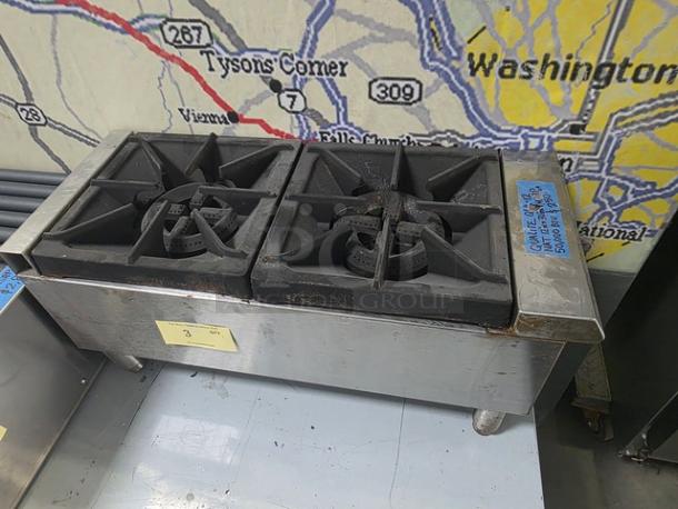 Qualite Gas Hotplate QLH-12, 2 burners, 50,000 BTU, industrial-grade, used condition with visible wear and leg supports.