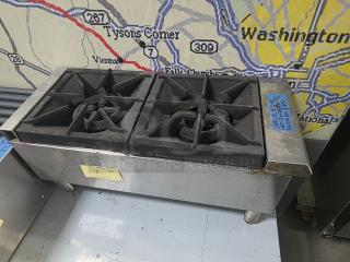 Qualite Gas Hotplate QLH-12, 2 burners, 50,000 BTU, industrial-grade, used condition with visible wear and leg supports.