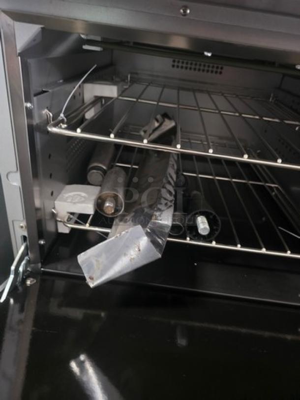 CPG 24" 4-burner electric range with Space Saver Oven; 208V, 3 PH; visibly bent bottom cover.